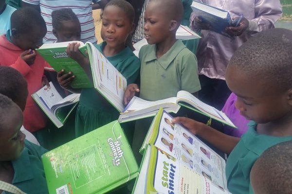 Children enjoying books donated by villageRISE International